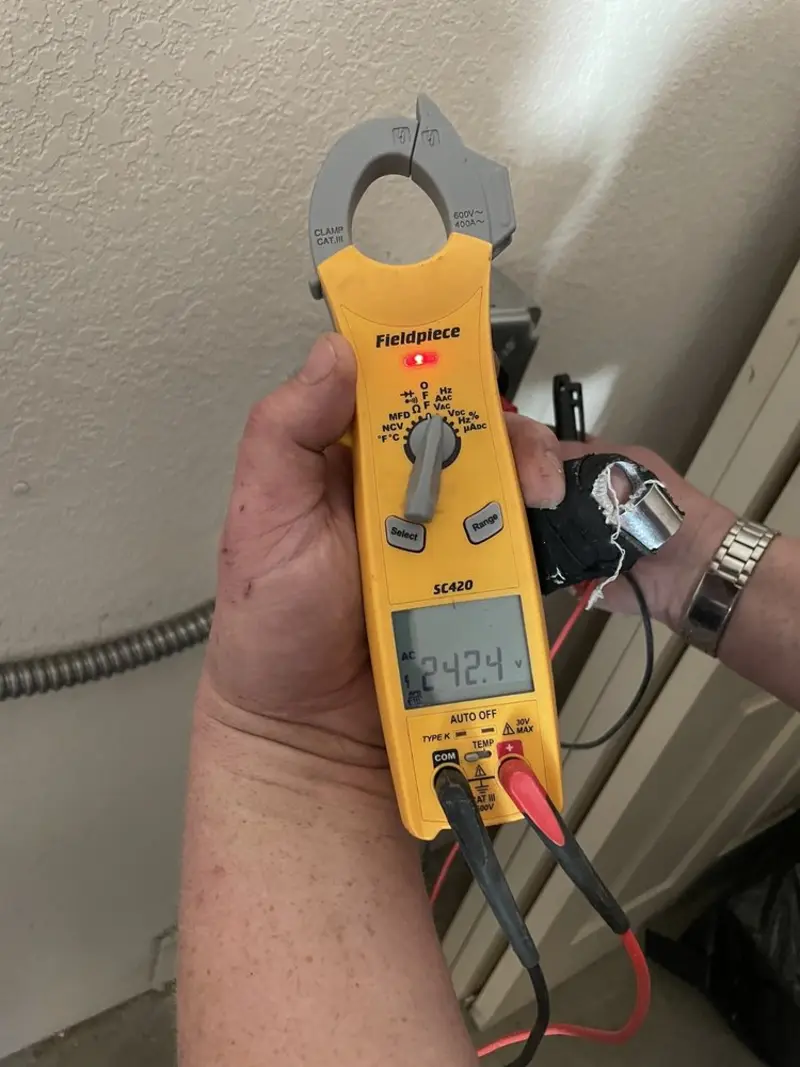 Voltage testing with clamp meter during Outlet Installation in Swartz Creek